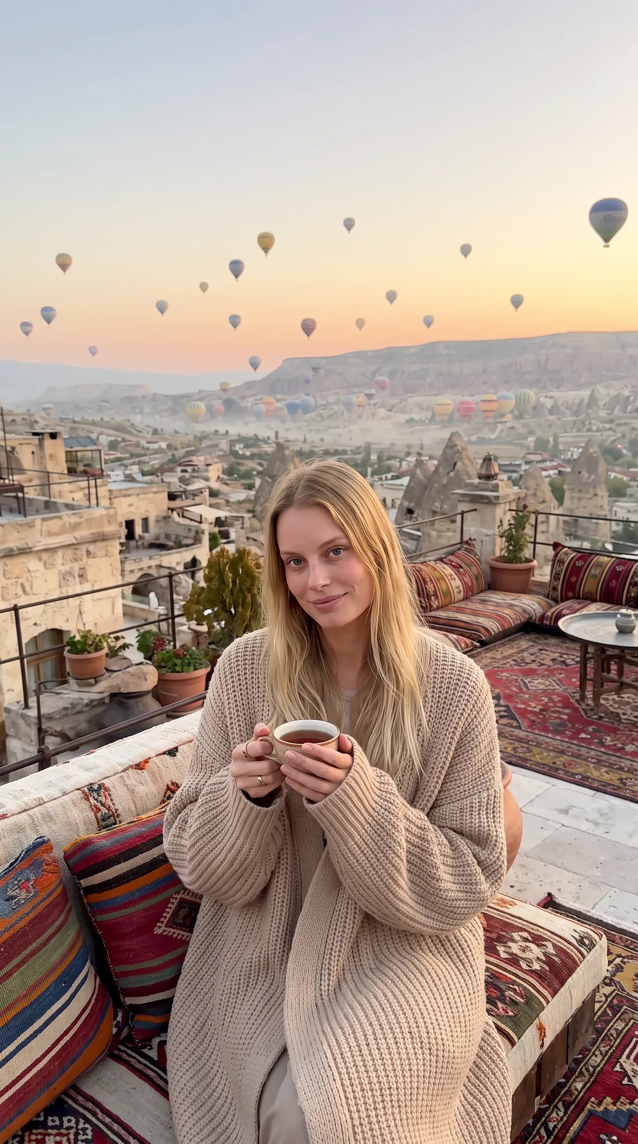 Sofia with tea on a Cappadocia rooftop at sunrise